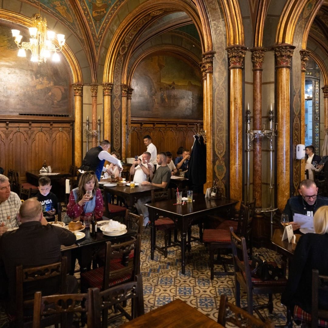 Mai multi oameni iau masa in restaurant caru cu Bere din București