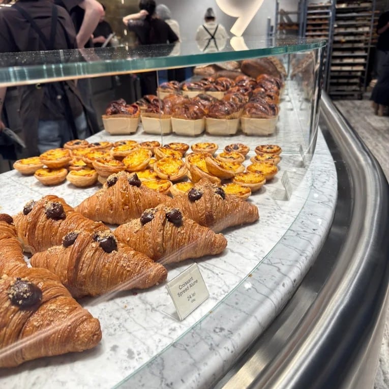 Croissante, tarte și viennoiserie artizanală expuse într-o vitrină modernă, parte din oferta de patiserie de la Piața 9 din Victoriei