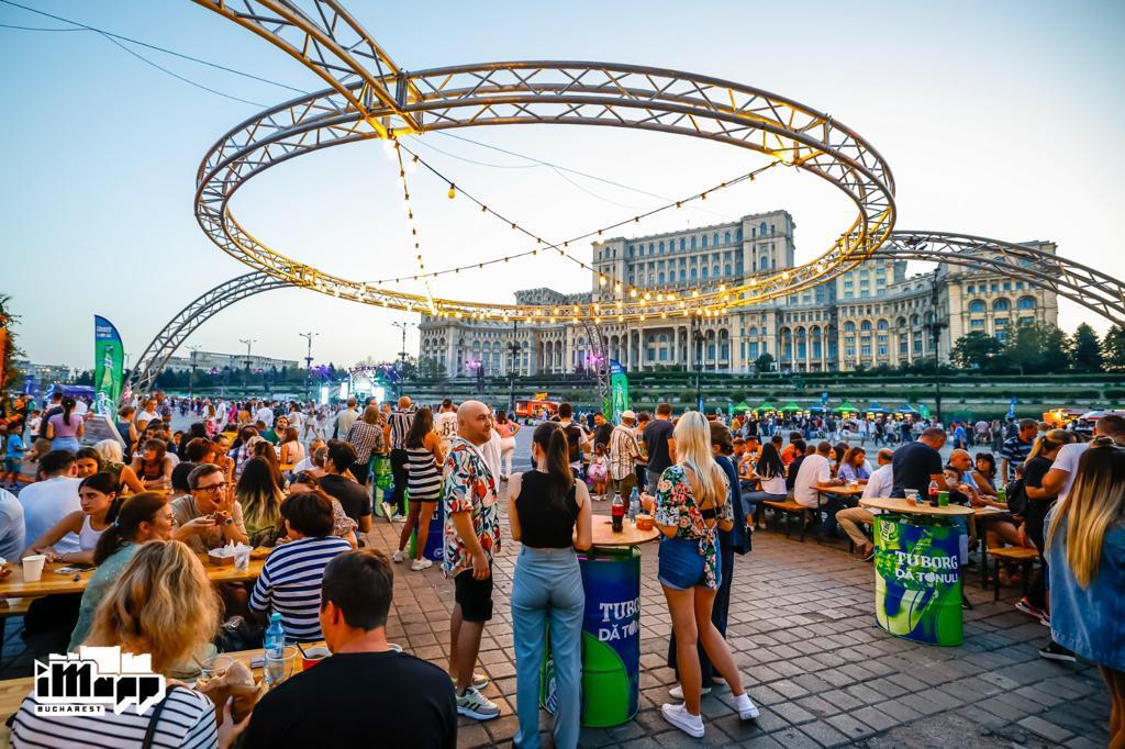 Bucharest Streetfood Festival x iMapp Bucharest. Piata Constitutiei, Bucuresti. Mai multe persoane iau masa la un festival stradal. Târguri gastroniomice de toamnă: 