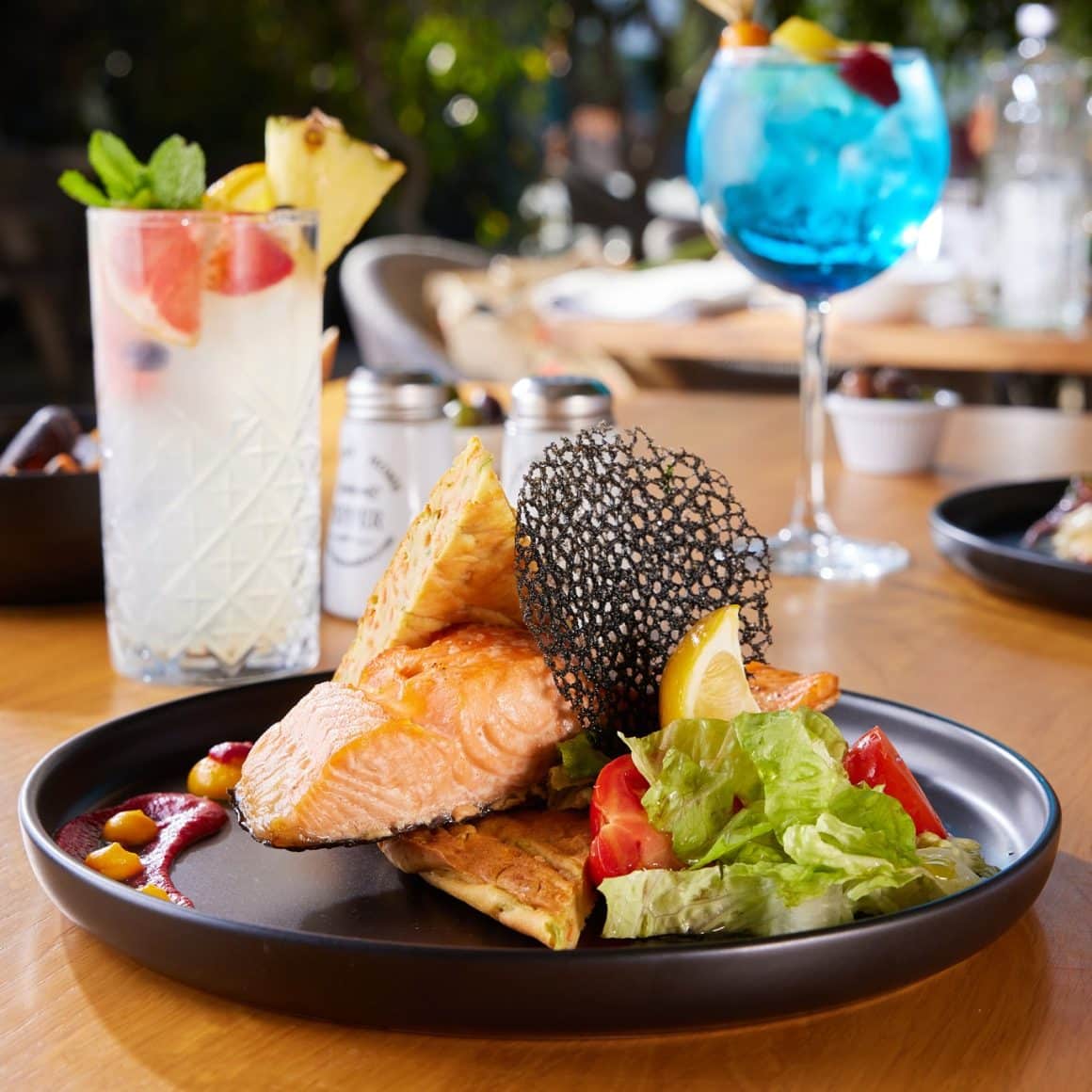 file de somon la grătar cu salată și cocktailuri colorate, restaurant Pescăruș București