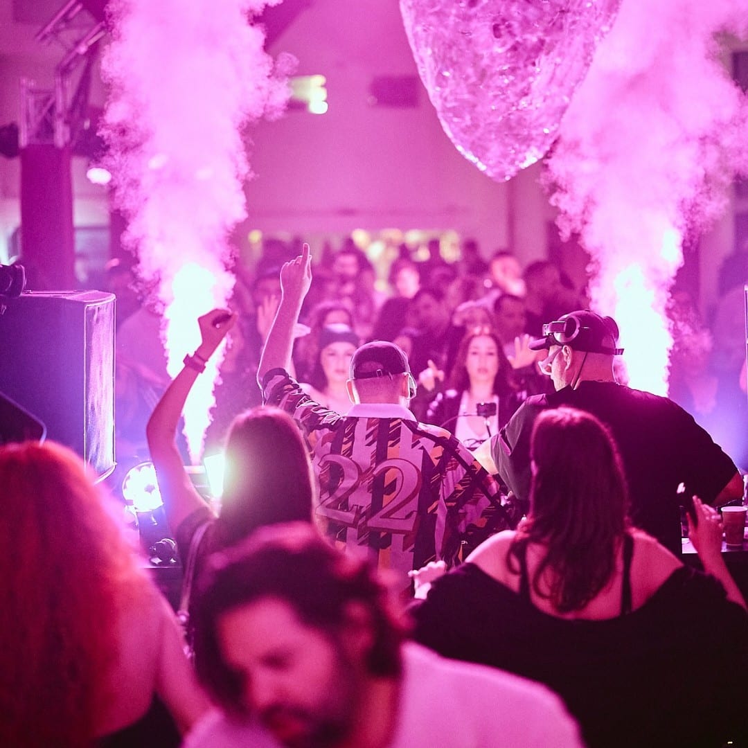 oameni care danseaza intr-un club cu dj live