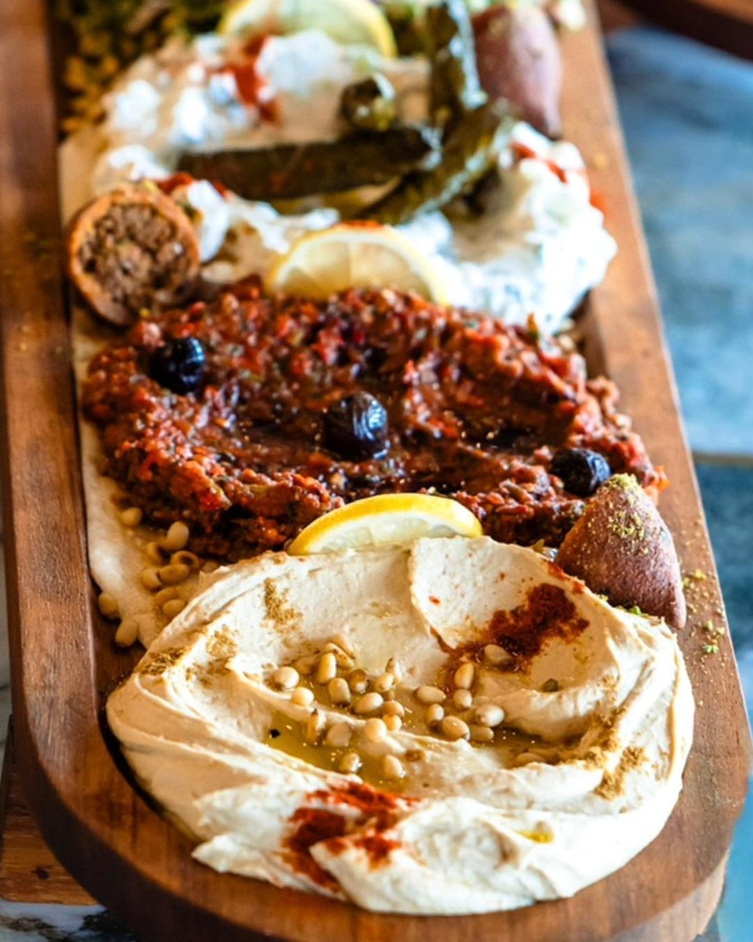 Hummus și muhammara cu muguri de pin, servite cu pâine proaspătă